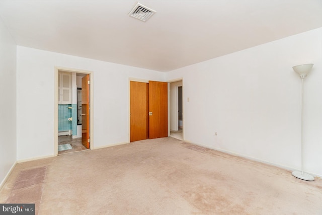 empty room with carpet flooring and a baseboard heating unit