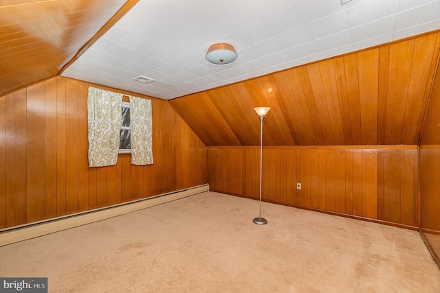 bonus room with light carpet, a baseboard heating unit, and wooden walls