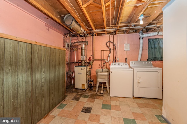 clothes washing area featuring independent washer and dryer and sink