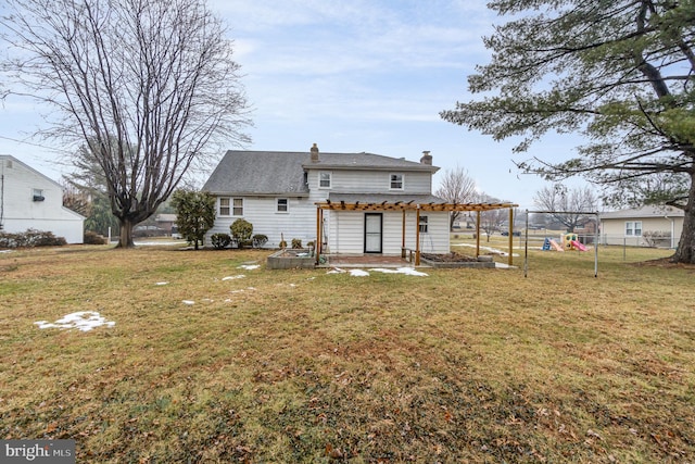 rear view of property with a pergola and a lawn