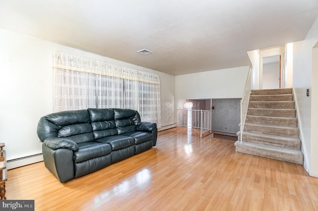 living room with a baseboard radiator and wood-type flooring