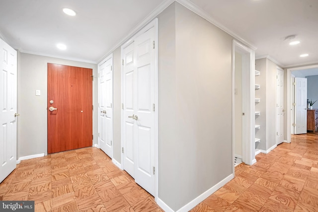 hall with ornamental molding and light parquet floors