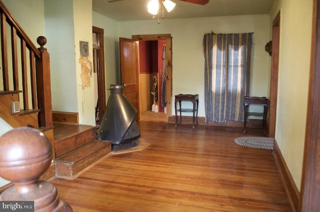 interior space with wood-type flooring and a wood stove