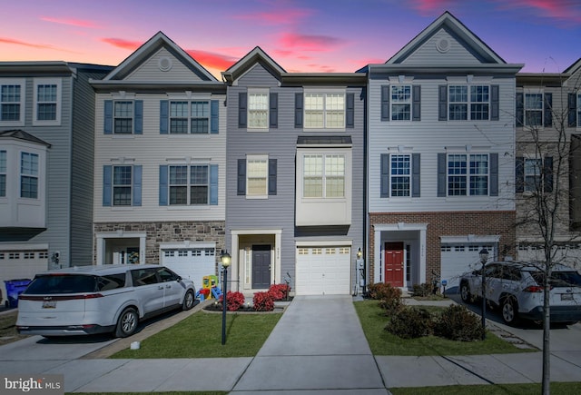 multi unit property featuring driveway and an attached garage