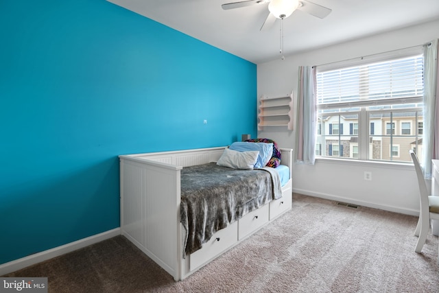 unfurnished bedroom with carpet floors, visible vents, baseboards, and a ceiling fan