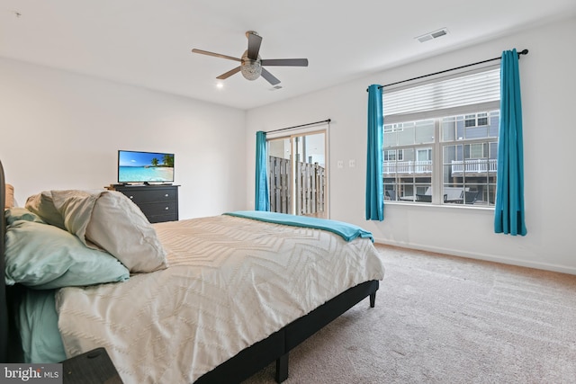 carpeted bedroom featuring ceiling fan, visible vents, and baseboards