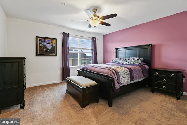 bedroom featuring baseboards, ceiling fan, and light colored carpet