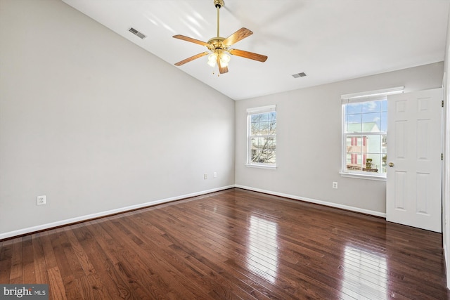 empty room featuring ceiling fan, dark hardwood / wood-style floors, and vaulted ceiling