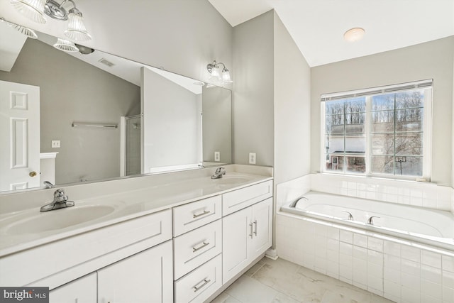 bathroom featuring vanity, plus walk in shower, and vaulted ceiling