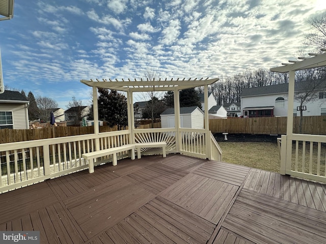 deck featuring a shed and a pergola