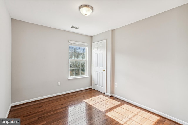 unfurnished room featuring hardwood / wood-style flooring