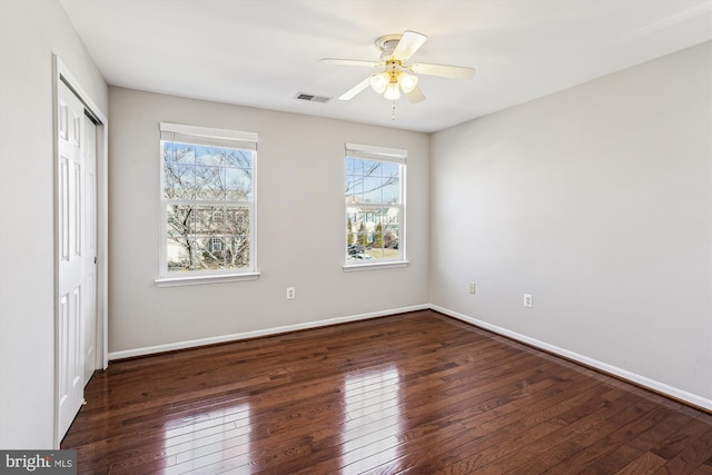 unfurnished bedroom featuring ceiling fan, dark hardwood / wood-style floors, and a closet