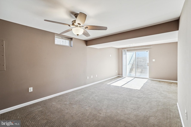 carpeted spare room with a healthy amount of sunlight and ceiling fan