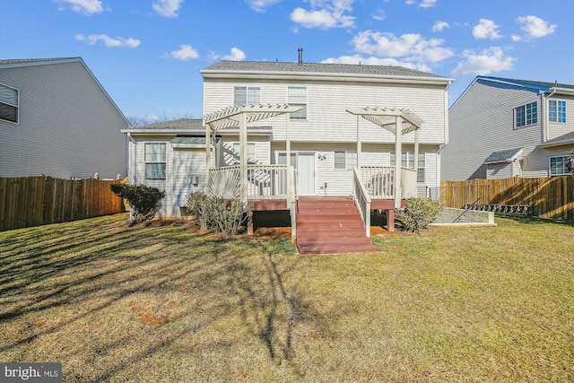 back of house featuring a wooden deck, a pergola, and a lawn