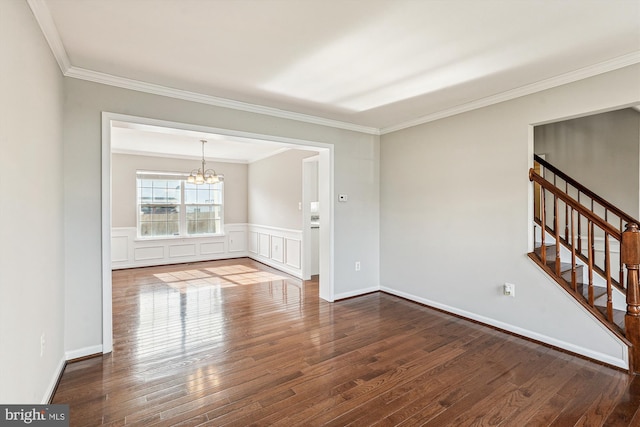 unfurnished room featuring a notable chandelier, crown molding, and wood-type flooring