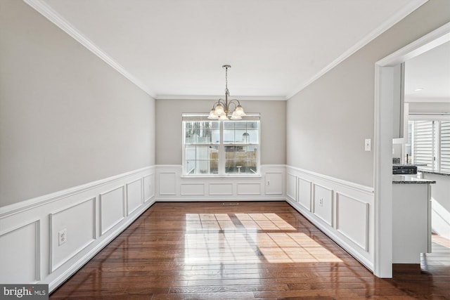 unfurnished dining area featuring hardwood / wood-style flooring, plenty of natural light, and a chandelier