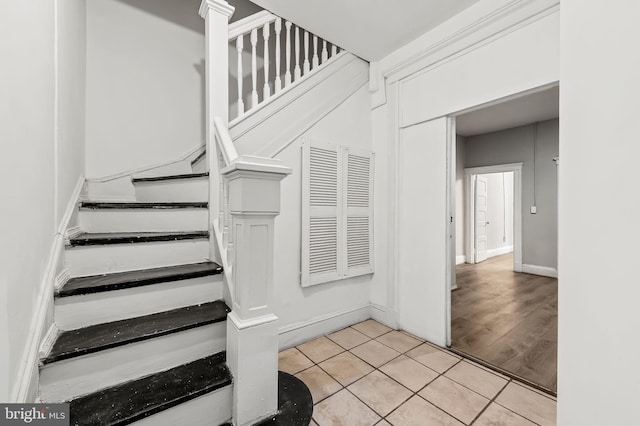 stairway featuring tile patterned floors