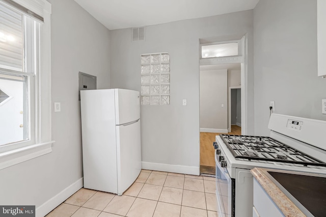 kitchen featuring white appliances and light tile patterned floors