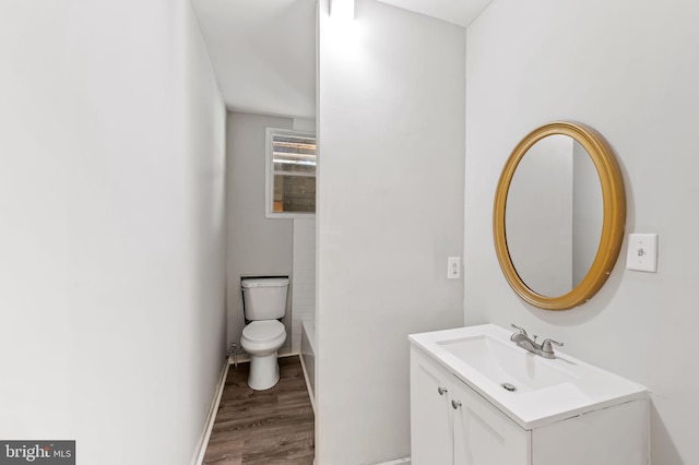 bathroom with vanity, wood-type flooring, and toilet