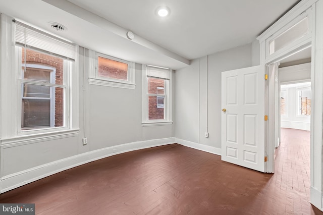 unfurnished room featuring dark hardwood / wood-style flooring