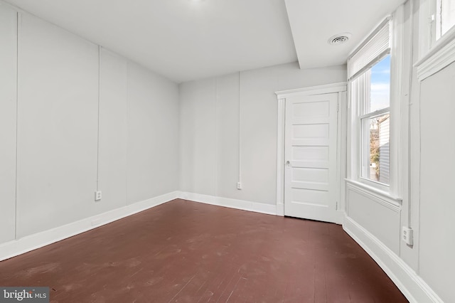 empty room with dark wood-type flooring