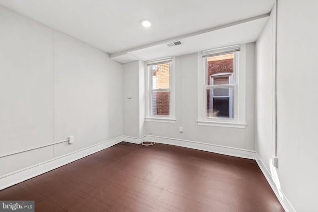 empty room featuring dark wood-type flooring