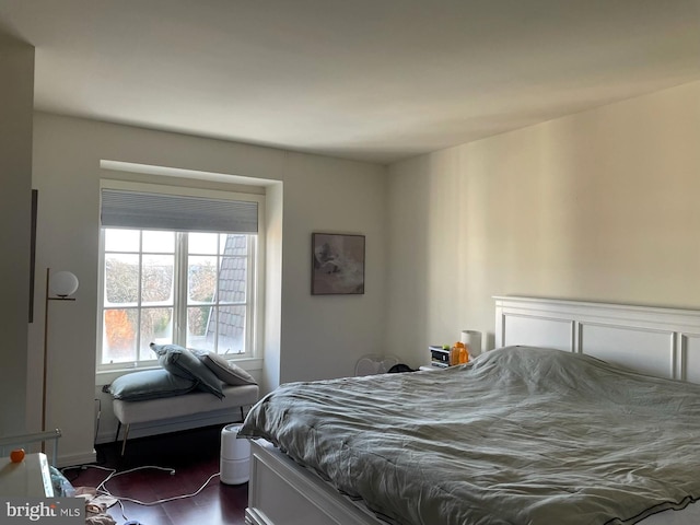 bedroom with dark hardwood / wood-style flooring