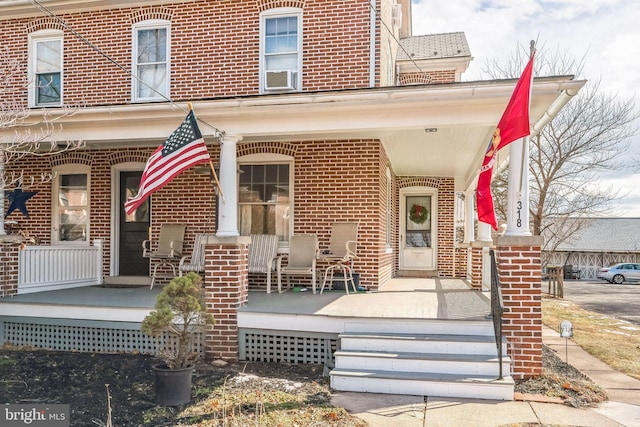 property entrance with cooling unit and covered porch