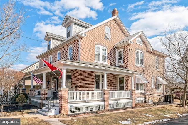 townhome / multi-family property featuring covered porch