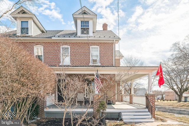 rear view of property featuring covered porch