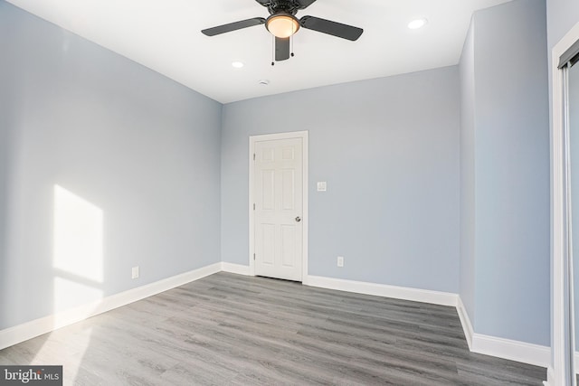 spare room with hardwood / wood-style floors and ceiling fan