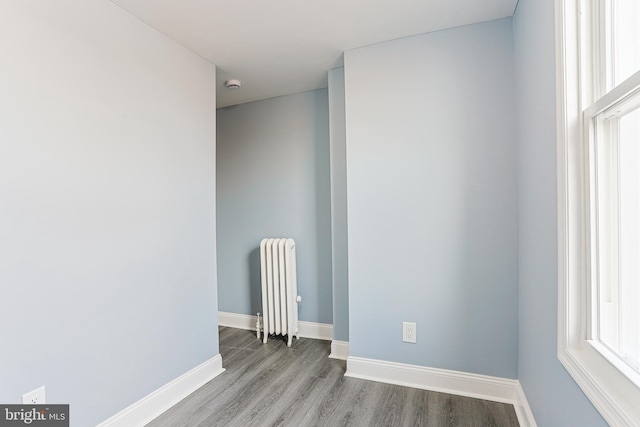 spare room with radiator and light hardwood / wood-style flooring