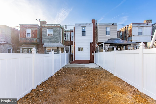 rear view of property featuring a gazebo