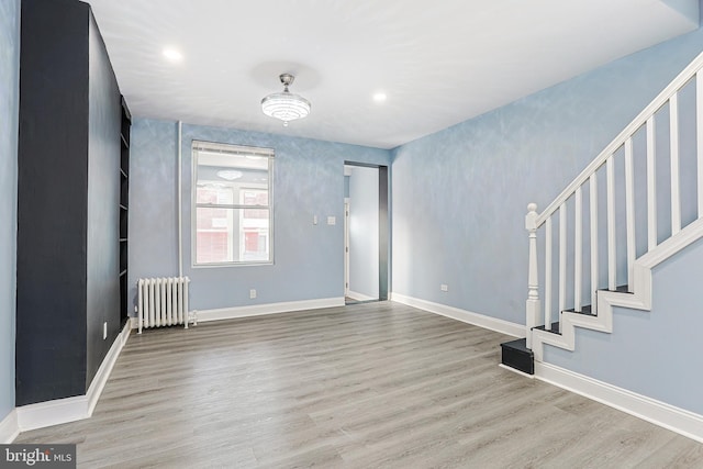 interior space featuring radiator and light hardwood / wood-style floors