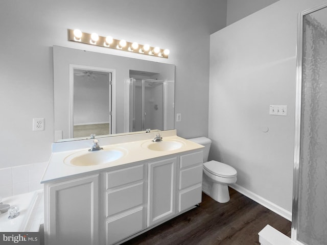 bathroom with vanity, hardwood / wood-style flooring, toilet, and walk in shower