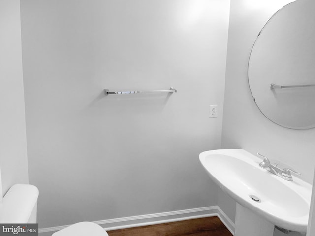 bathroom featuring sink, hardwood / wood-style floors, and toilet