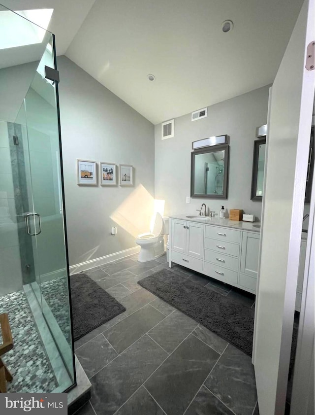 full bathroom with toilet, vanity, visible vents, vaulted ceiling, and a shower stall