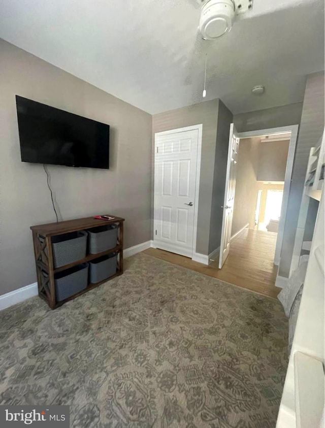 interior space featuring baseboards and wood finished floors