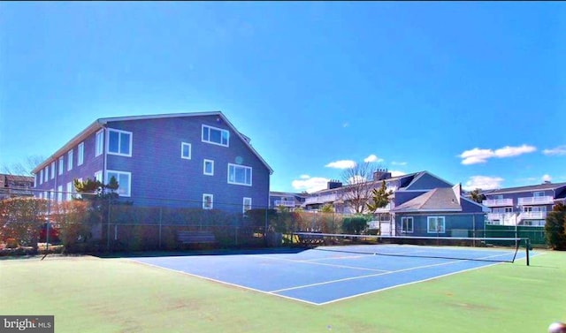 view of tennis court with fence