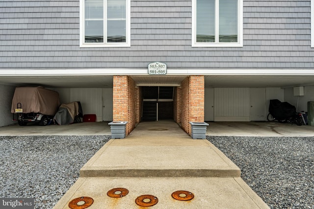 view of exterior entry with brick siding