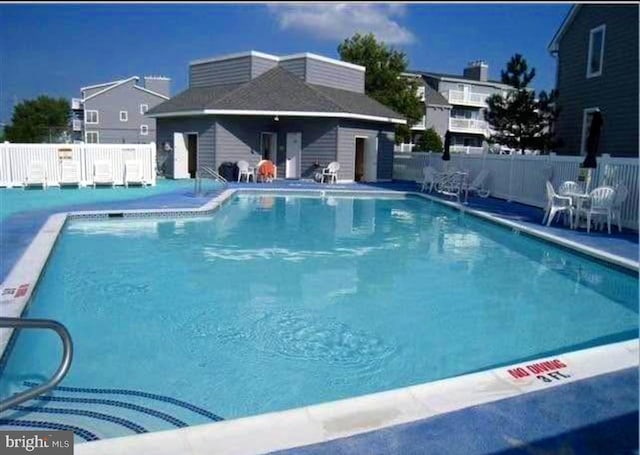 pool featuring a patio area and fence