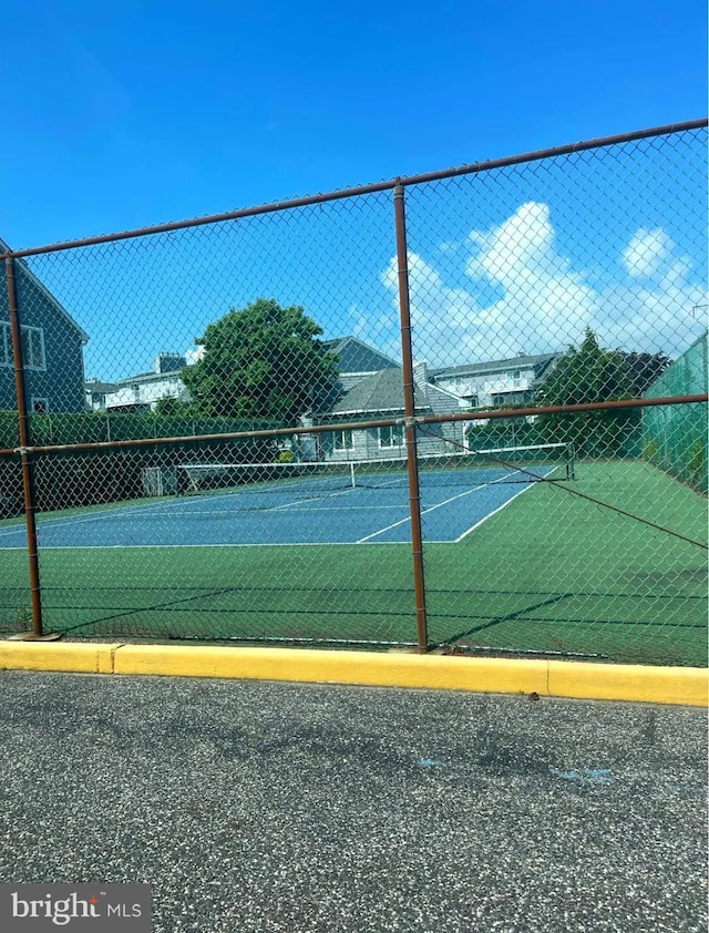 view of tennis court with fence