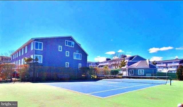 view of sport court featuring fence