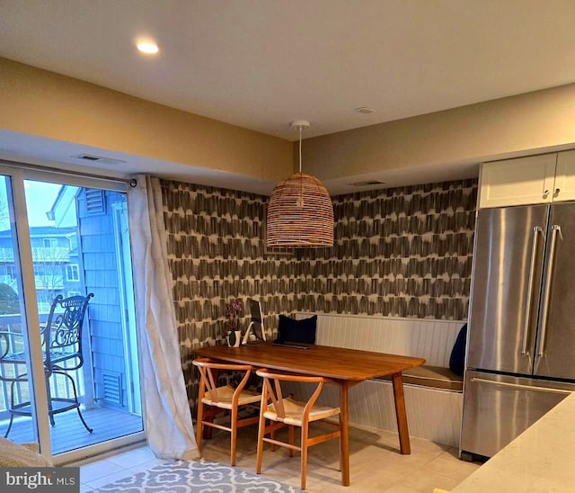 wine room with wainscoting and recessed lighting