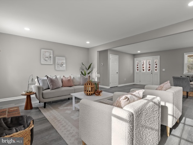 living room featuring recessed lighting, baseboards, and wood finished floors