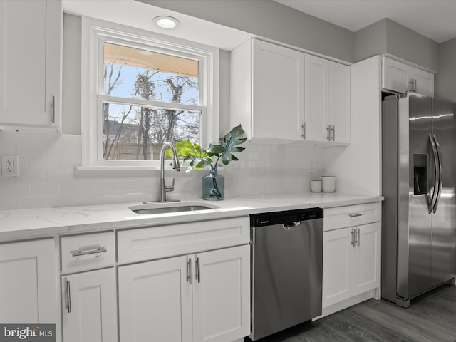 kitchen featuring appliances with stainless steel finishes, a sink, and white cabinets