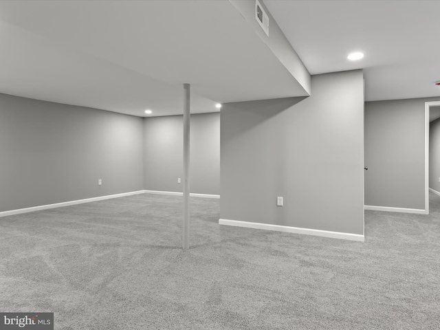 finished below grade area with recessed lighting, carpet flooring, visible vents, and baseboards