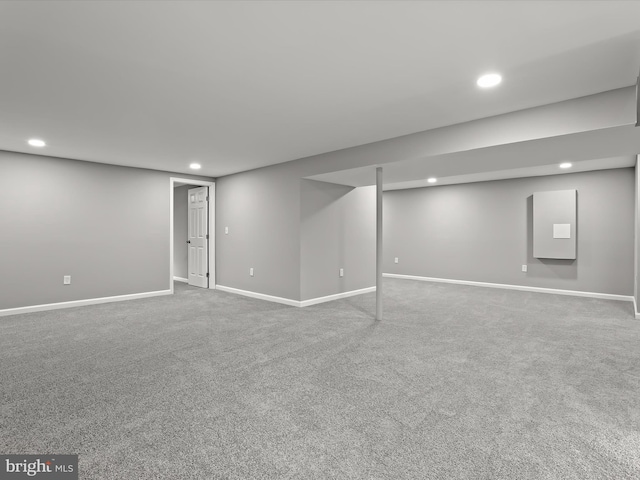 finished basement with carpet floors, baseboards, and recessed lighting