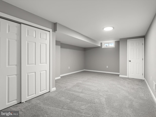 below grade area with carpet and baseboards