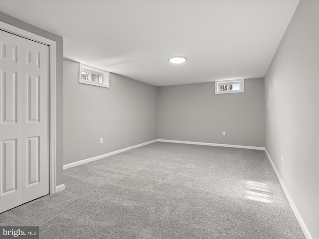 basement featuring carpet floors and baseboards